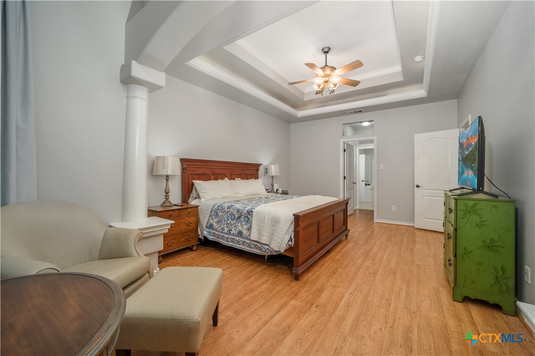 103 Sierra Ridge Drive San Marcos, TX 78666 - Photo 24 of 43 a bedroom with a bed and a chandelier