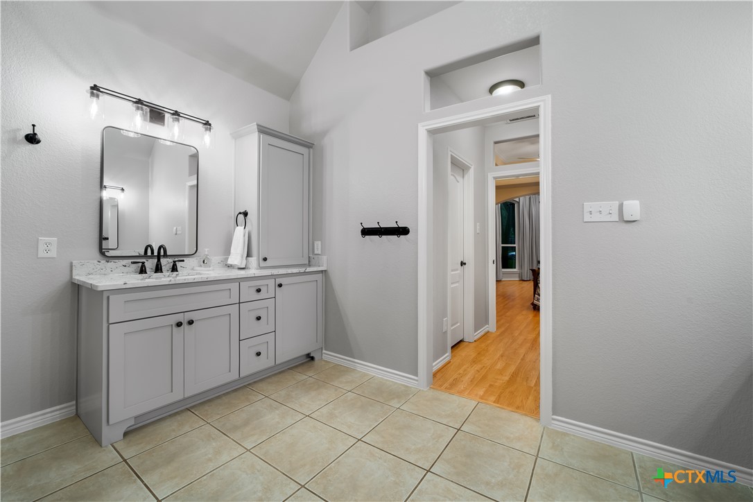 103 Sierra Ridge Drive San Marcos, TX 78666 - Photo 25 of 43 a spacious bathroom with a mirror sink and shower