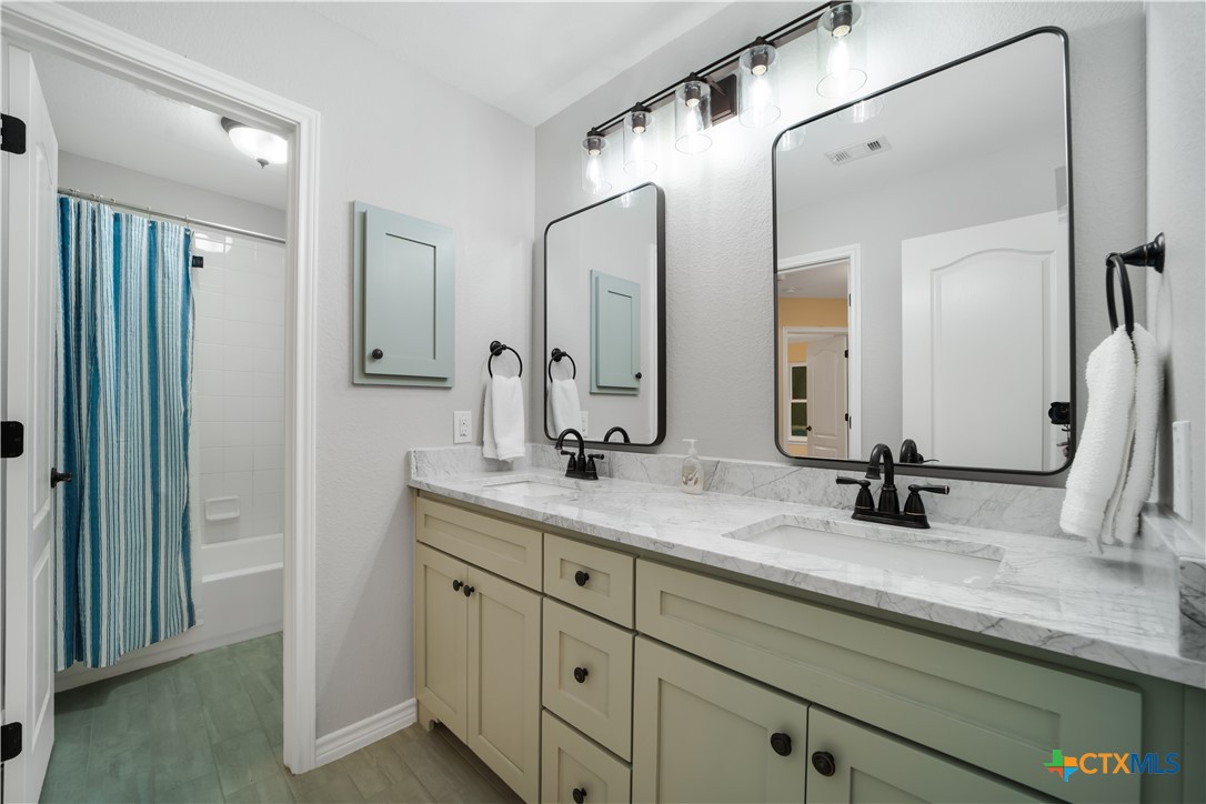 103 Sierra Ridge Drive San Marcos, TX 78666 - Photo 31 of 43 a bathroom with a double vanity sink mirror and double