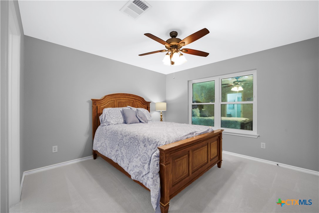 103 Sierra Ridge Drive San Marcos, TX 78666 - Photo 33 of 43 a bedroom with a bed and window