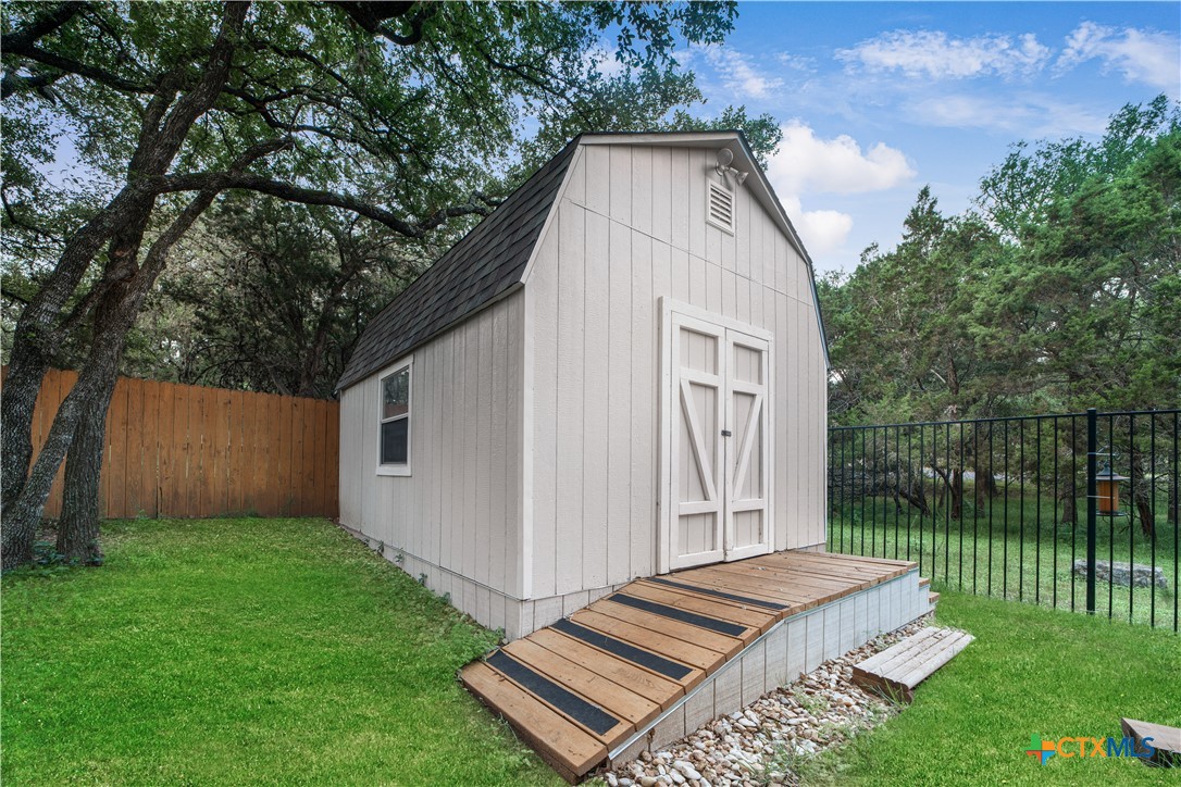 103 Sierra Ridge Drive San Marcos, TX 78666 - Photo 37 of 43 a backyard of a house with lots of green space