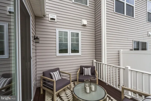 a balcony with table and chairs