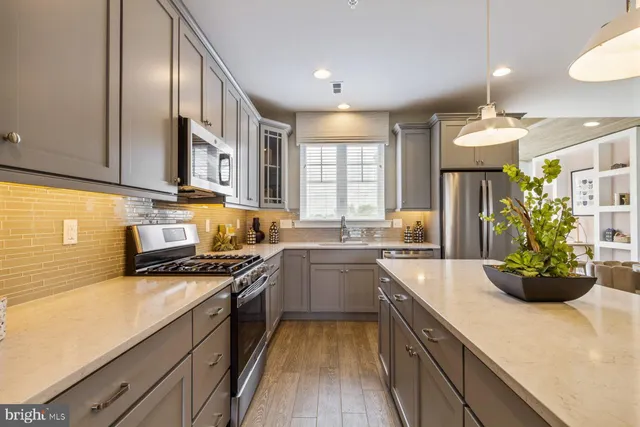 a kitchen with a sink stainless steel appliances and cabinets