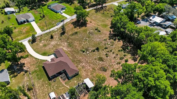an aerial view of a house with a yard and garden