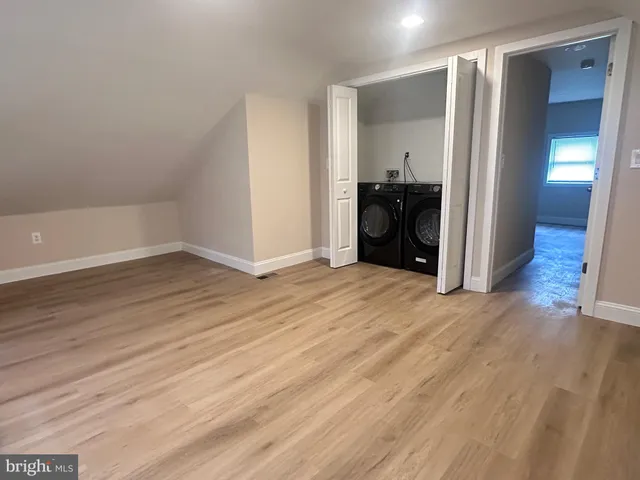 an empty room with wooden floor and closet