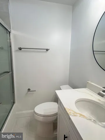 a bathroom with a sink a toilet and a shower