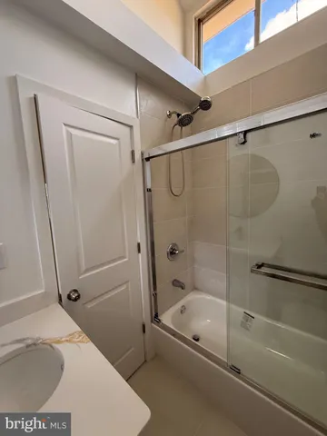 a bathroom with a tub a sink and a shower