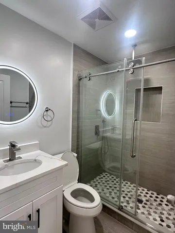 a bathroom with a sink toilet and shower