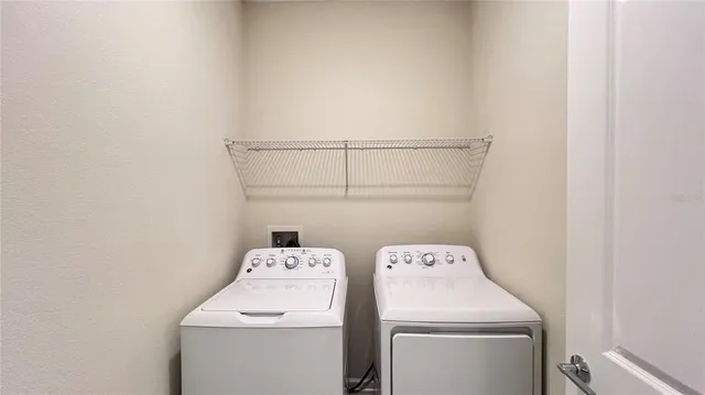 a kitchen with stainless steel appliances kitchen island granite countertop a refrigerator and a stove top oven