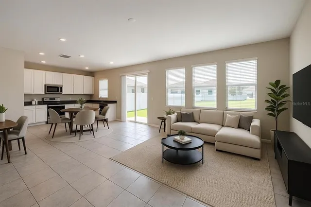 a living room with furniture and a large window