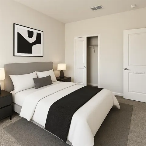 a bedroom with bed and painting on the wall