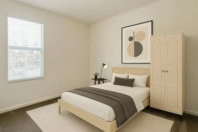 a bedroom with a bed and a window