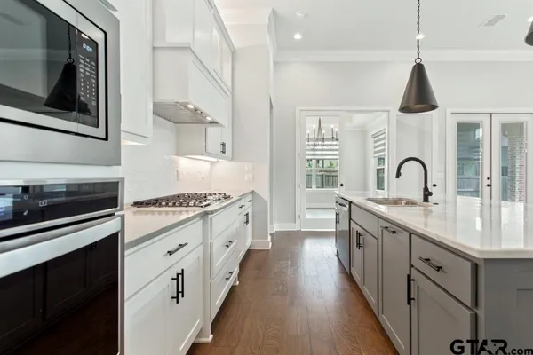 a kitchen with sink and cabinets