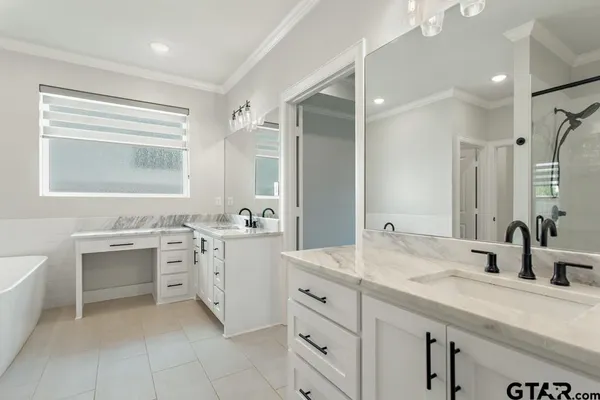 a bathroom with a sink double vanity and a mirror