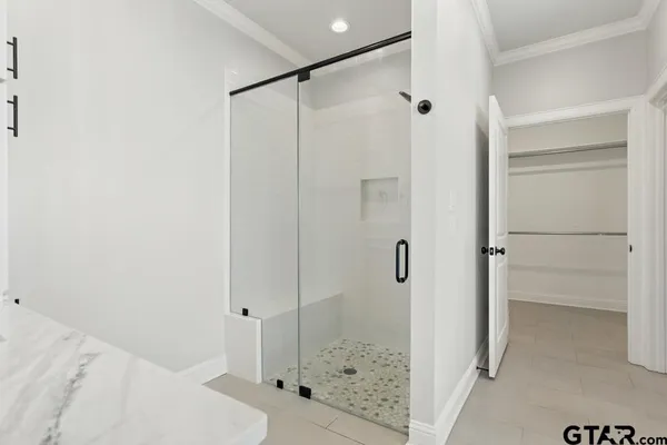 a bathroom with a glass shower door
