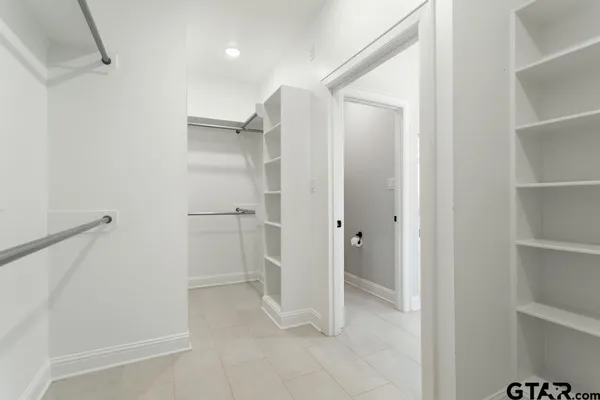 a bathroom with a shower and a glass door