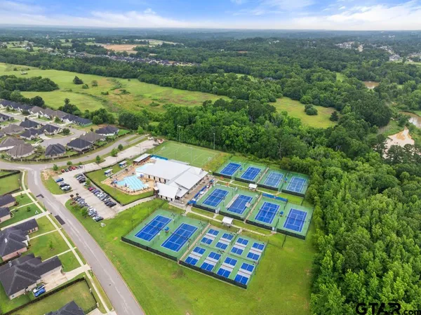 an aerial view of residential houses with outdoor space and river