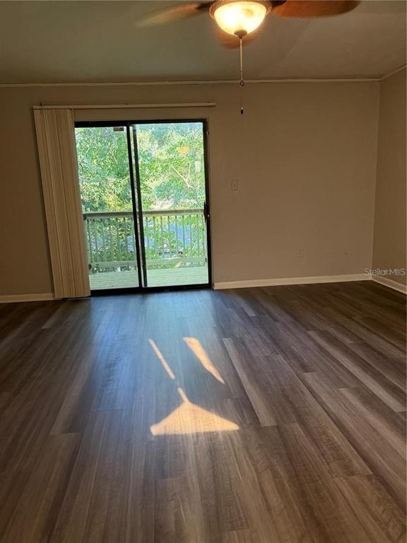 4313 Southwest 68th Terrace Gainesville, FL 32608 - Photo 7 of 14 a view of an empty room with wooden floor and a window