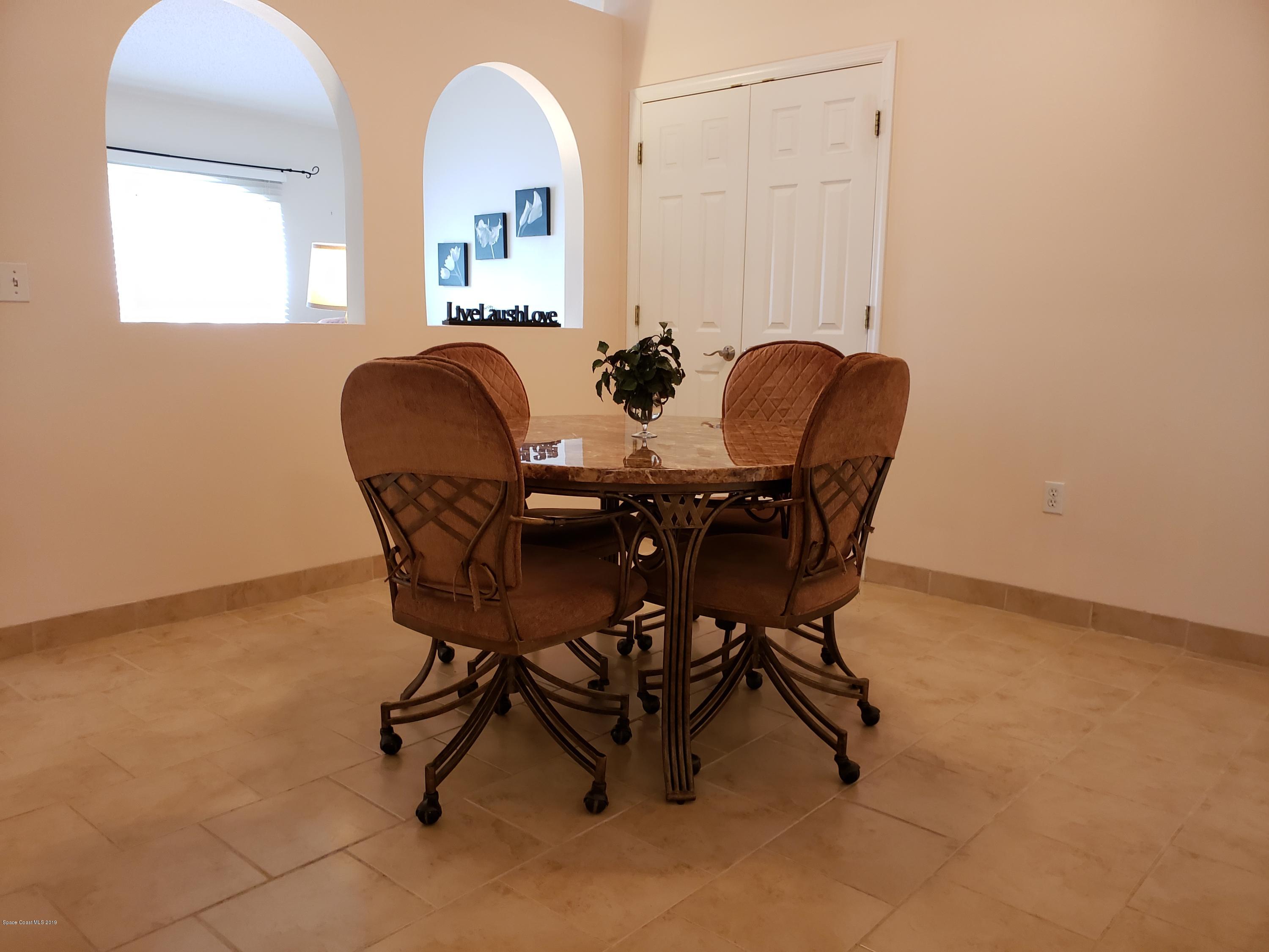 6145 Adina Road Cocoa, FL 32927 - Photo 13 of 34 a dining room with furniture and window