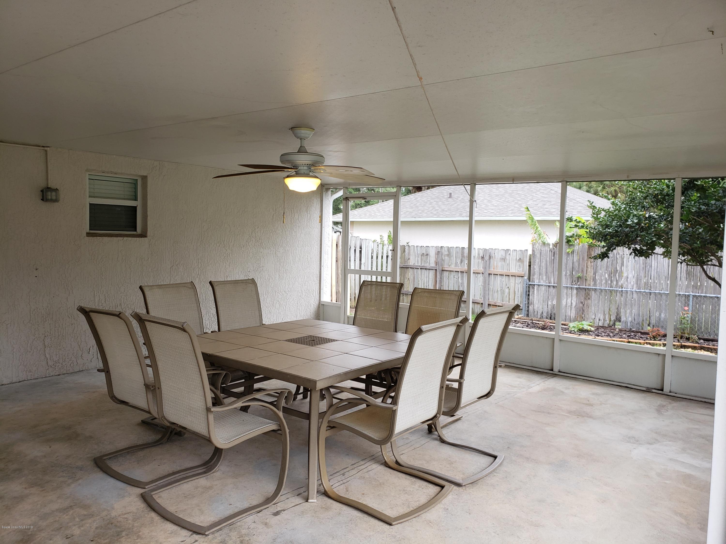 6145 Adina Road Cocoa, FL 32927 - Photo 21 of 34 a dining room with furniture and a floor to ceiling window