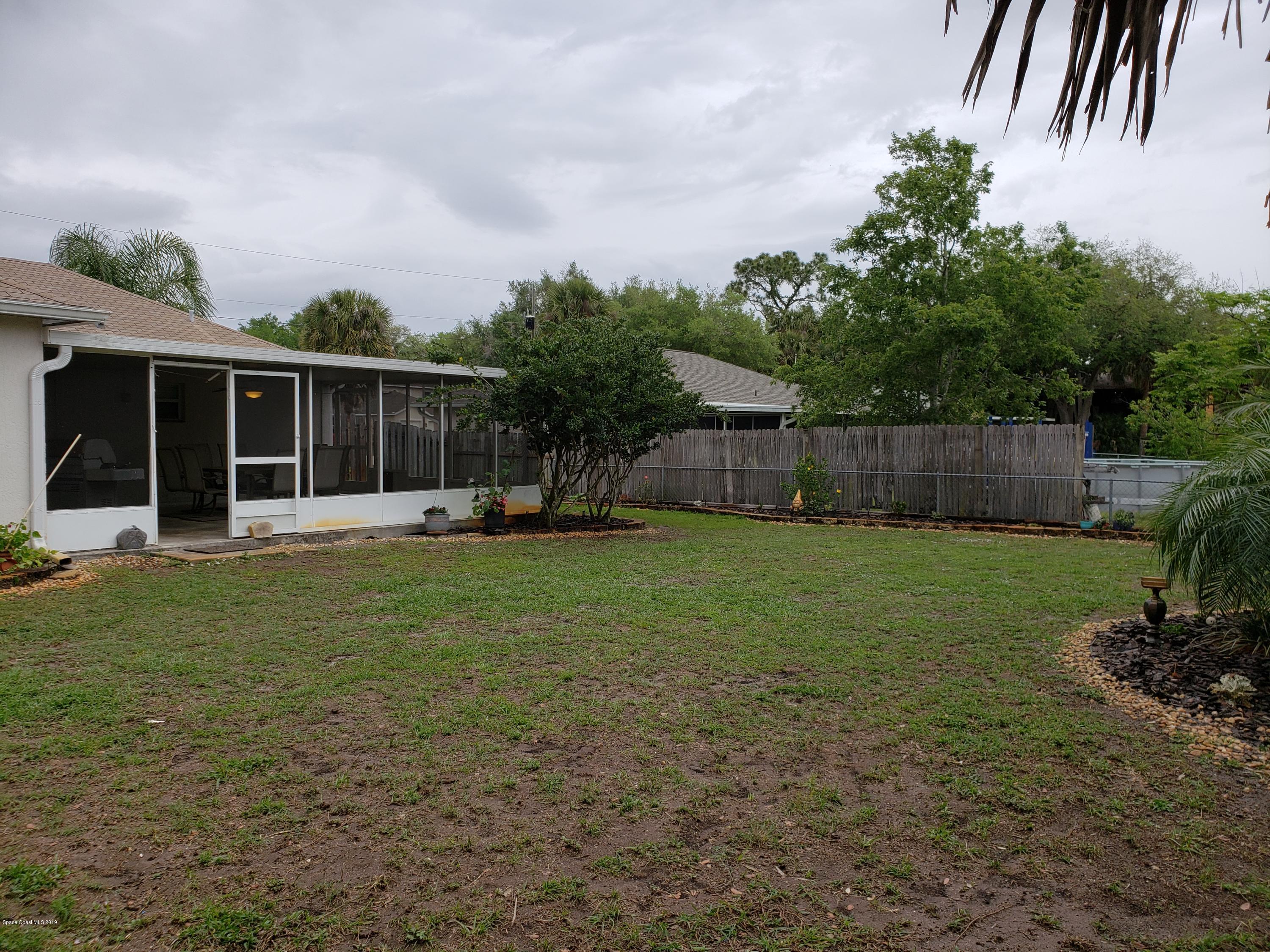 6145 Adina Road Cocoa, FL 32927 - Photo 27 of 34 a backyard of a house with lots of green space