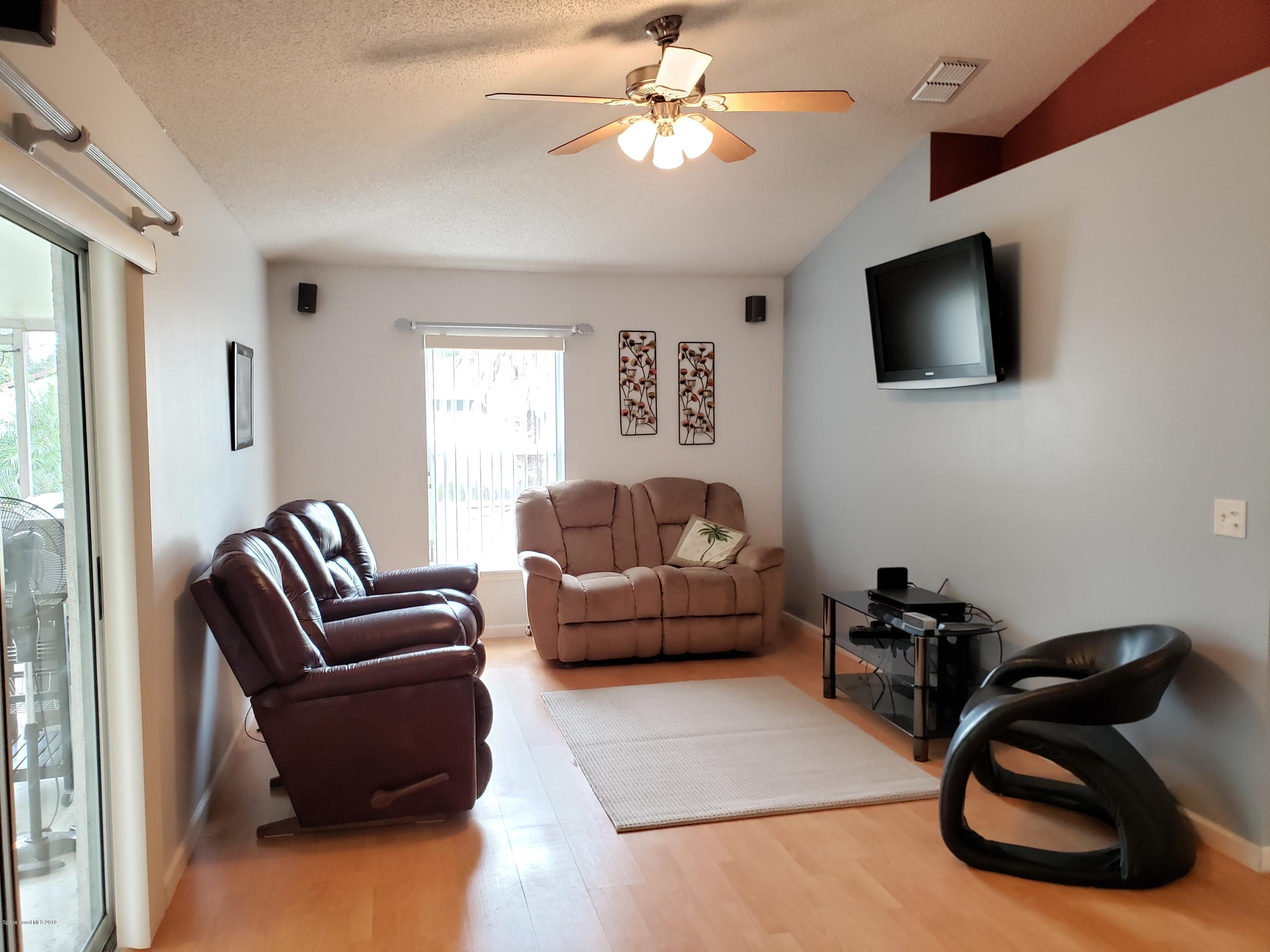 6145 Adina Road Cocoa, FL 32927 - Photo 4 of 34 a living room with furniture and a flat screen tv