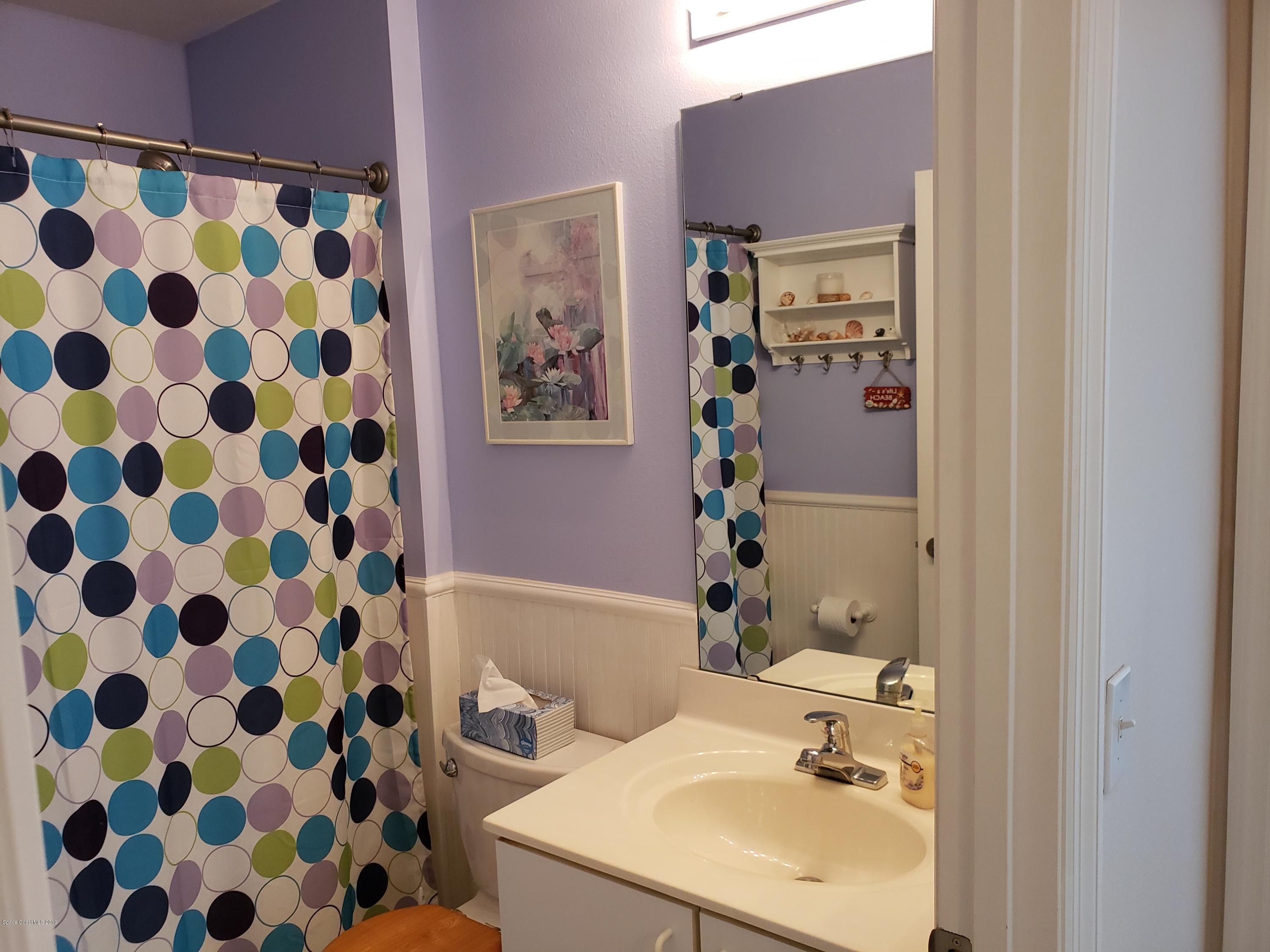 6145 Adina Road Cocoa, FL 32927 - Photo 6 of 34 a bathroom with a sink toilet and shower
