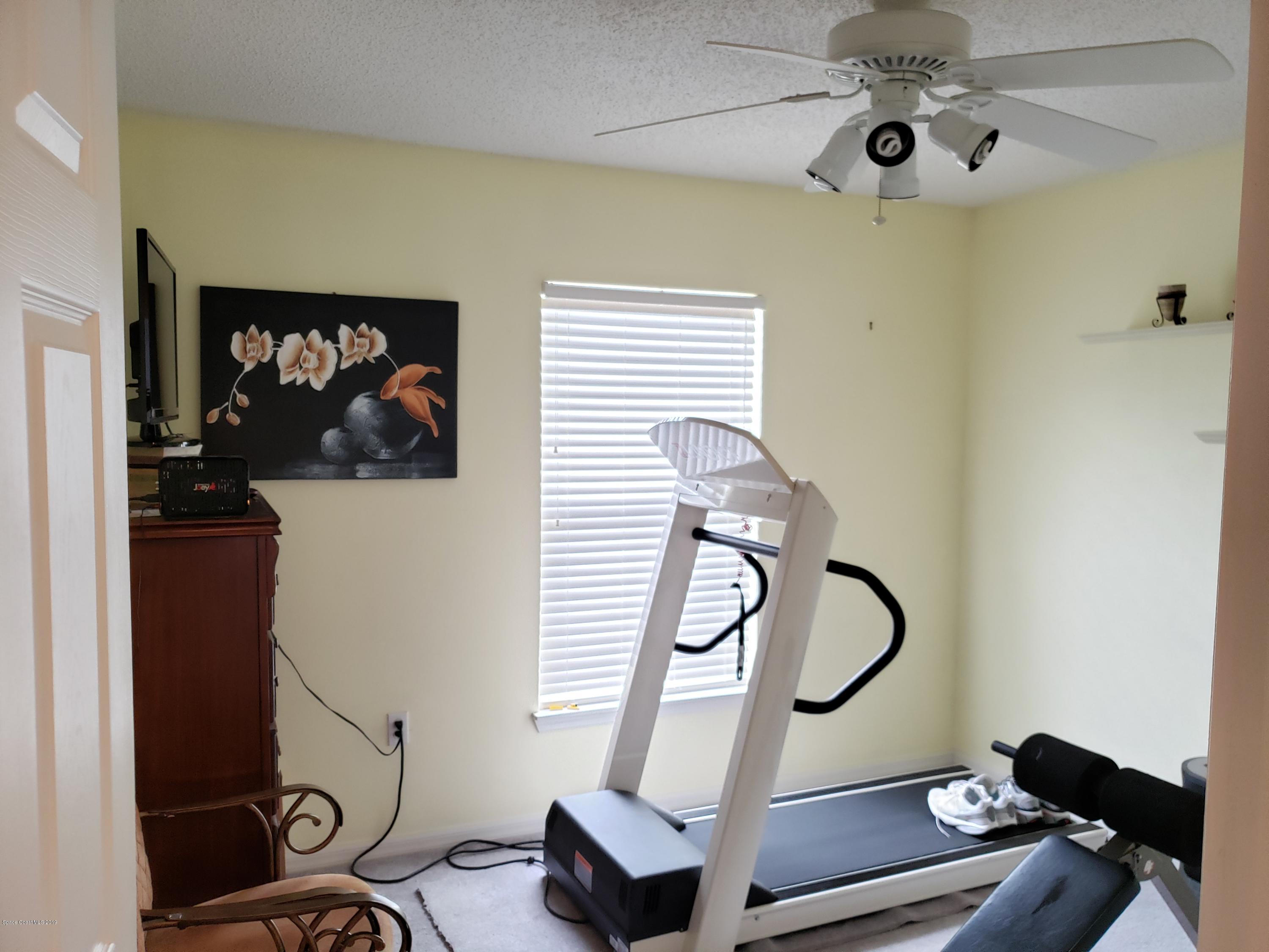 6145 Adina Road Cocoa, FL 32927 - Photo 8 of 34 a view of a room with gym equipment
