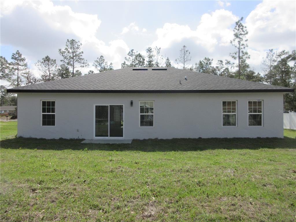 6765 Southwest 152nd Lane Road Ocala, FL 34473 - Photo 14 of 14 a house with a garden