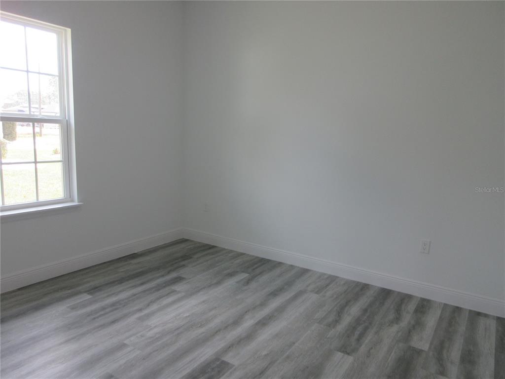6765 Southwest 152nd Lane Road Ocala, FL 34473 - Photo 6 of 14 an empty room with a window