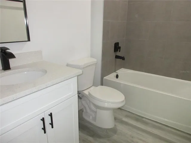 a bathroom with a sink a toilet and bathtub