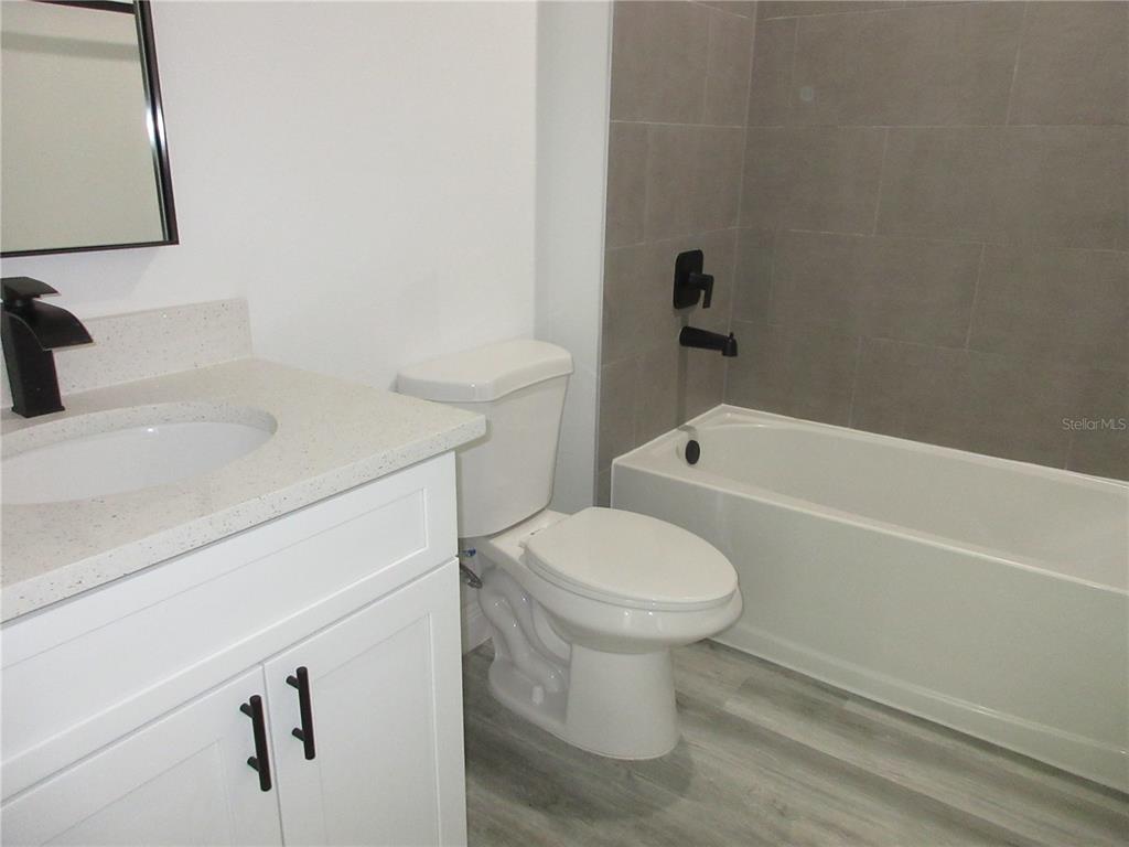6765 Southwest 152nd Lane Road Ocala, FL 34473 - Photo 7 of 14 a bathroom with a sink a toilet and bathtub