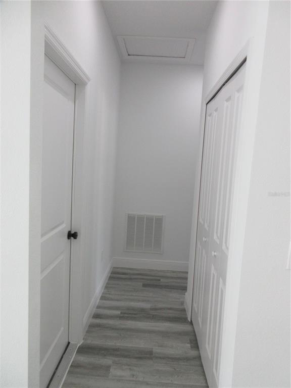 6765 Southwest 152nd Lane Road Ocala, FL 34473 - Photo 10 of 14 a view of a hallway with wooden floor and entryway