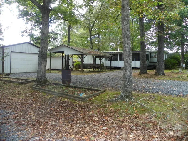 a backyard of a house with barbeque oven