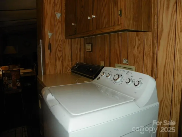 a close up of a utility room with dryer and washer