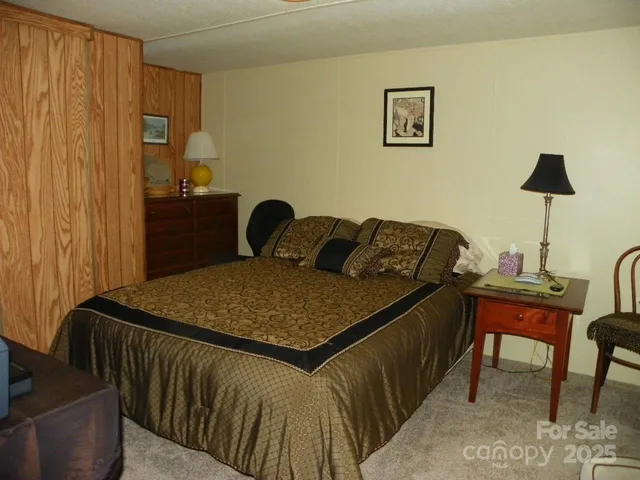 a bed sitting in a bedroom next to a window