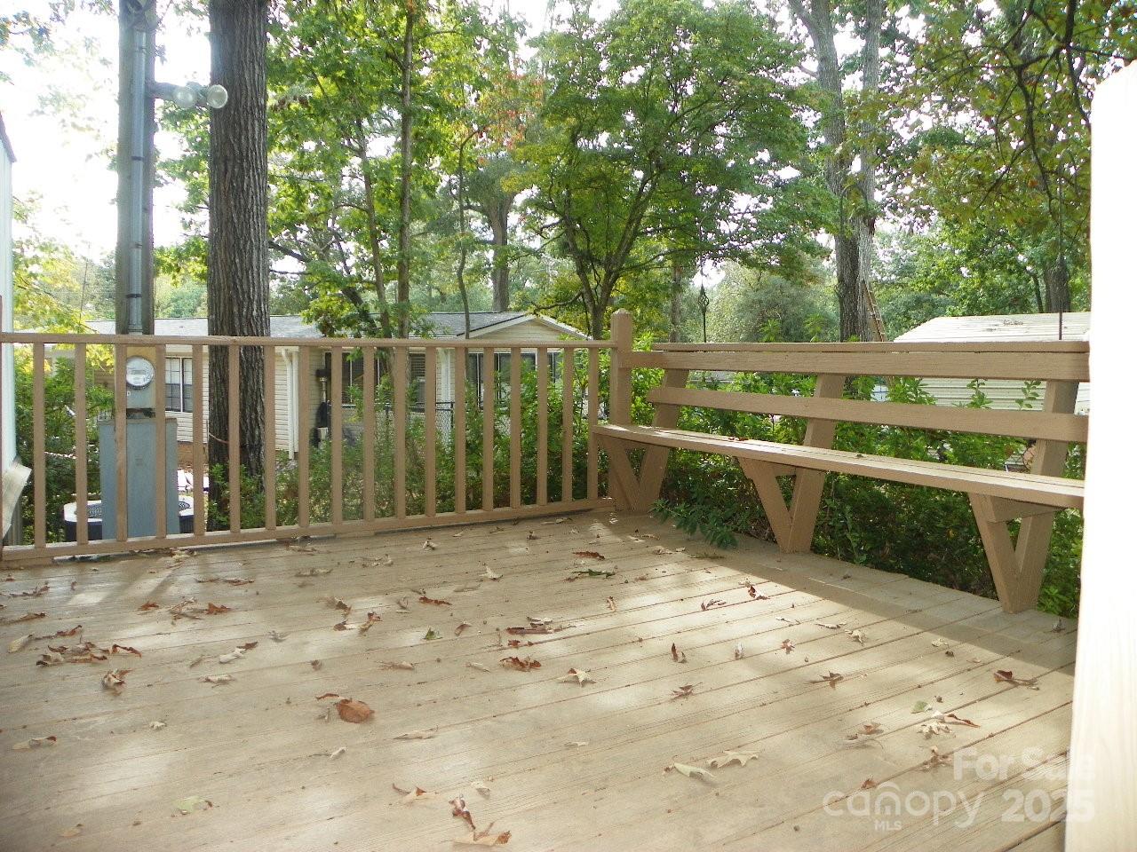 116 3rd Avenue New London, NC 28127 - Photo 3 of 18 a view of a backyard with large trees and wooden fence