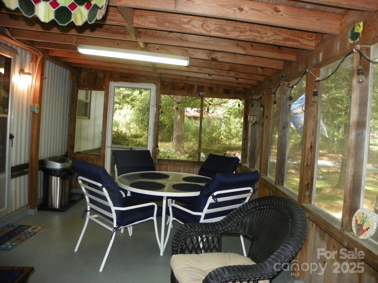 116 3rd Avenue New London, NC 28127 - Photo 6 of 18 a dining room with furniture and a floor to ceiling window