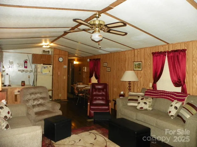 a living room with furniture a air conditioner and a dining table