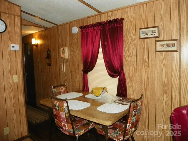 a view of a dining room with furniture and entryway