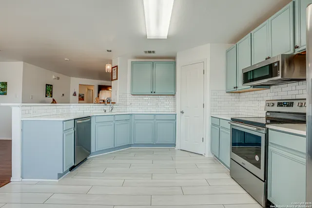a living room with furniture and large windows