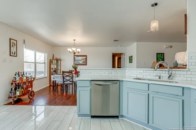 a kitchen with a stove a sink and a refrigerator