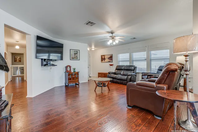 a living room with furniture and wooden floor