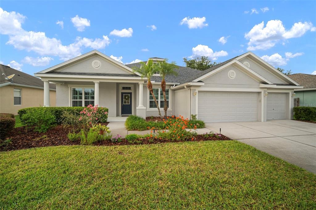 a front view of a house with a yard and garage