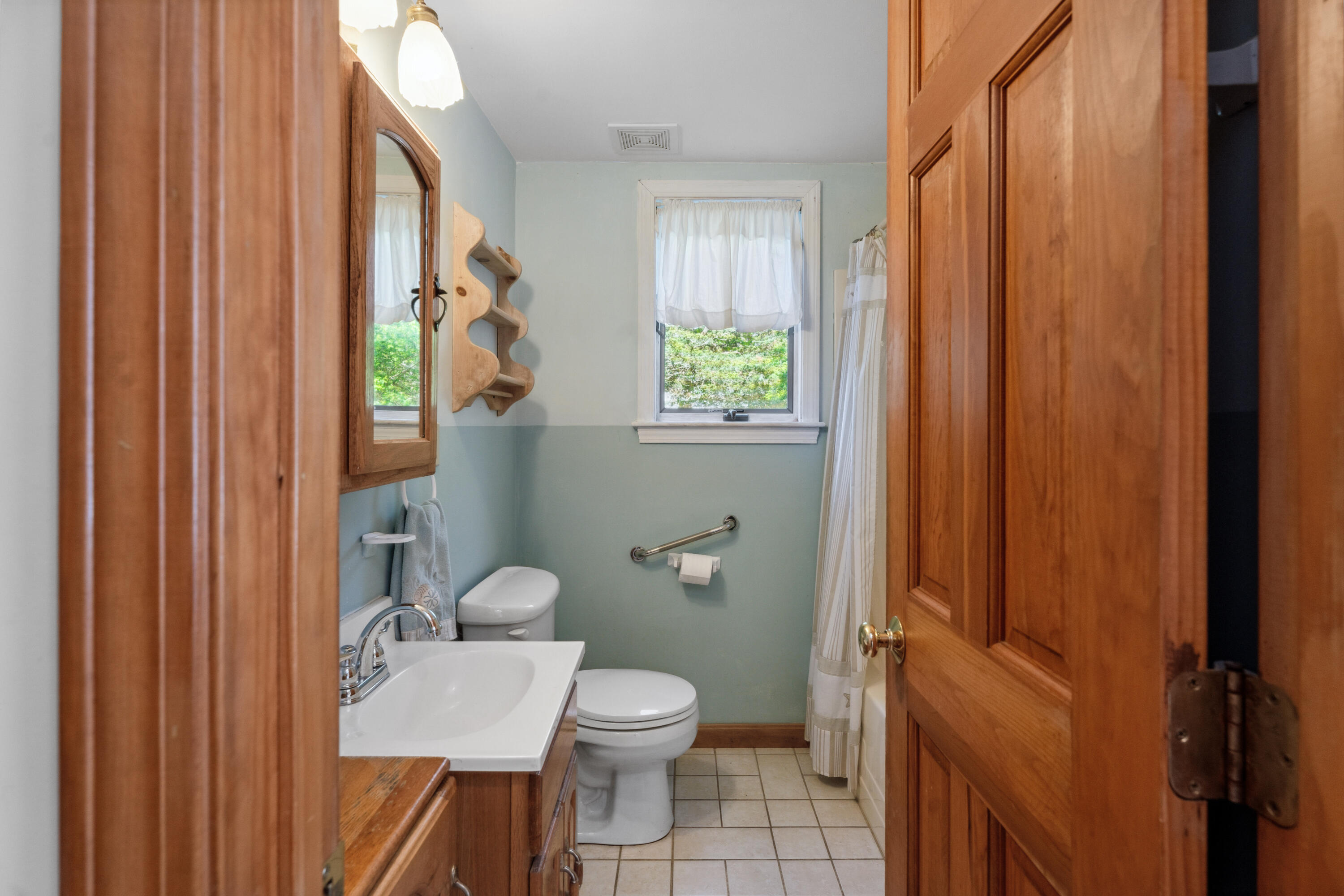 5 Bell Road Bourne, MA 02532 - Photo 12 of 26 a bathroom with a toilet a sink and a mirror