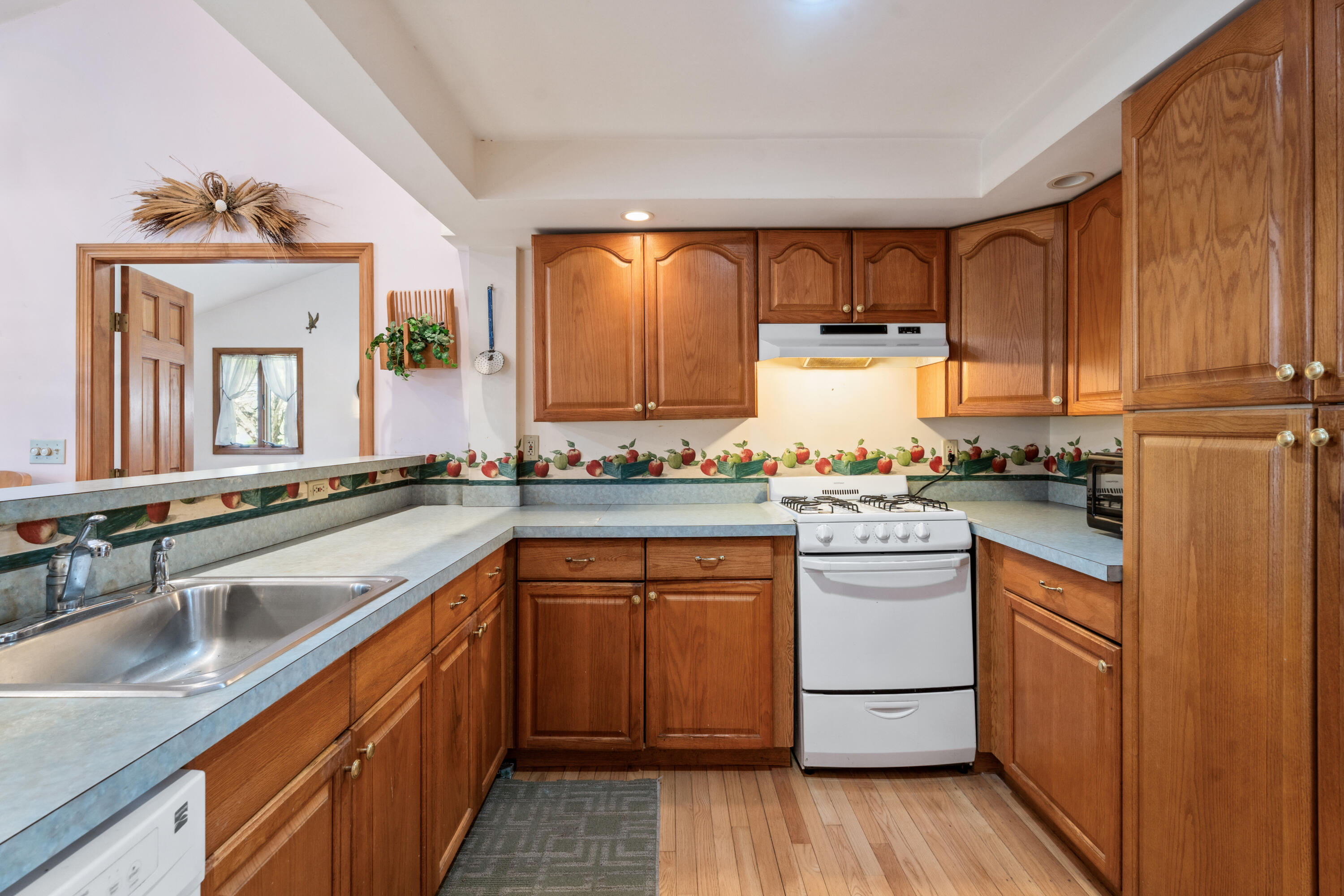 5 Bell Road Bourne, MA 02532 - Photo 9 of 26 a kitchen with a sink window and cabinets