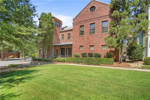 a front view of a building with a yard
