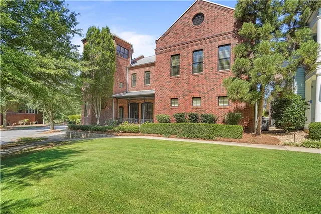 a front view of a house with a tree