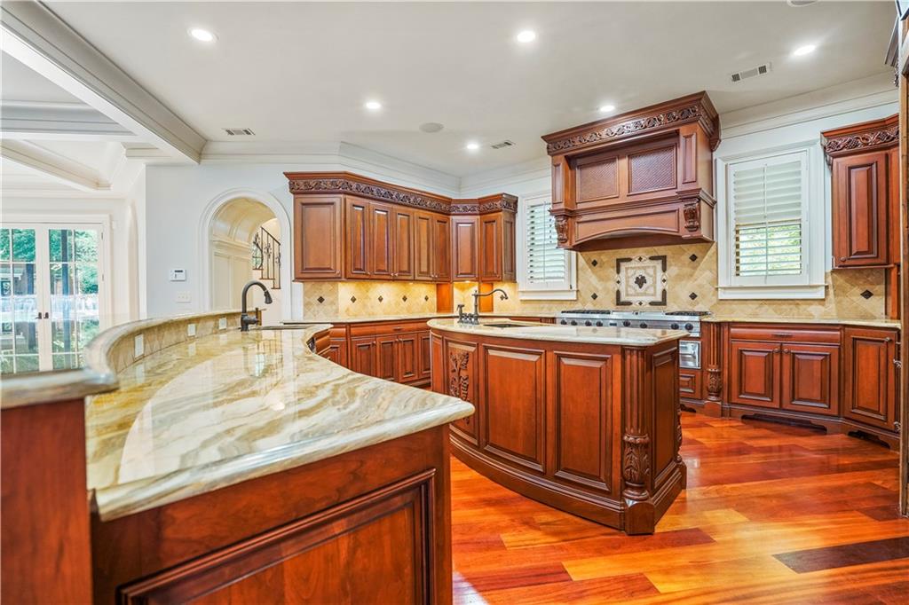 5102 Park Street Covington, GA 30014 - Photo 14 of 97 a kitchen with stainless steel appliances granite countertop a sink stove and cabinets