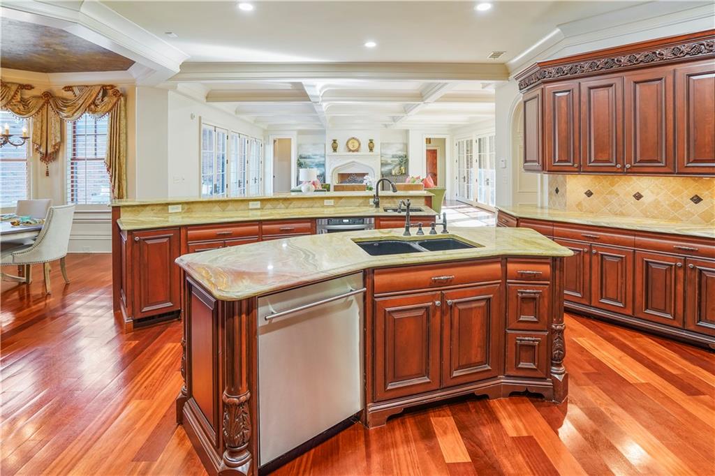 5102 Park Street Covington, GA 30014 - Photo 15 of 97 a kitchen with stainless steel appliances granite countertop a sink and cabinets